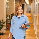 Person Walking with Laptop in hand